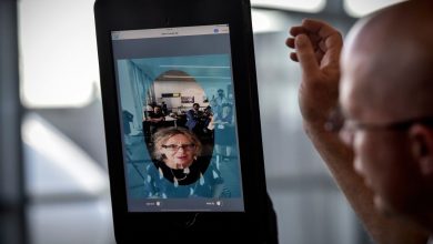 a facial recognition tablet used at Dulles Airport featuring someone's face