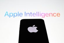 In this photo illustration, the 'Apple' logo is displayed on a mobile phone screen in front of a computer screen displaying Apple Intelligence logo.