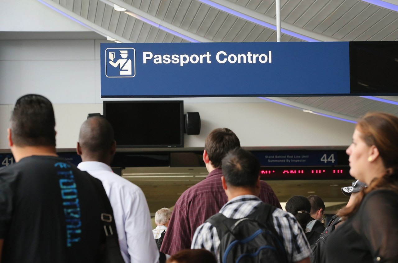 International travelers wait to have their passports checked at O'Hare International Airport on September 19, 2014 in Chicago, Illinois