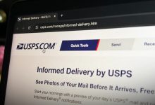 a photo of USPS' website home page on a computer display in the dark