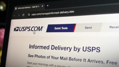 a photo of USPS' website home page on a computer display in the dark